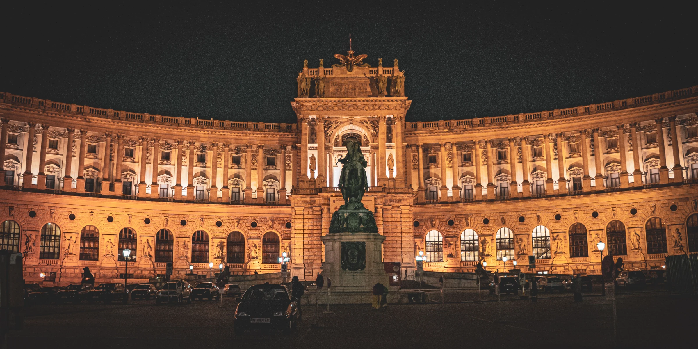 Illuminated historic architecture of Vienna’s Hofburg at night